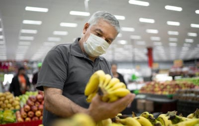 Man holding a banana on a grocery